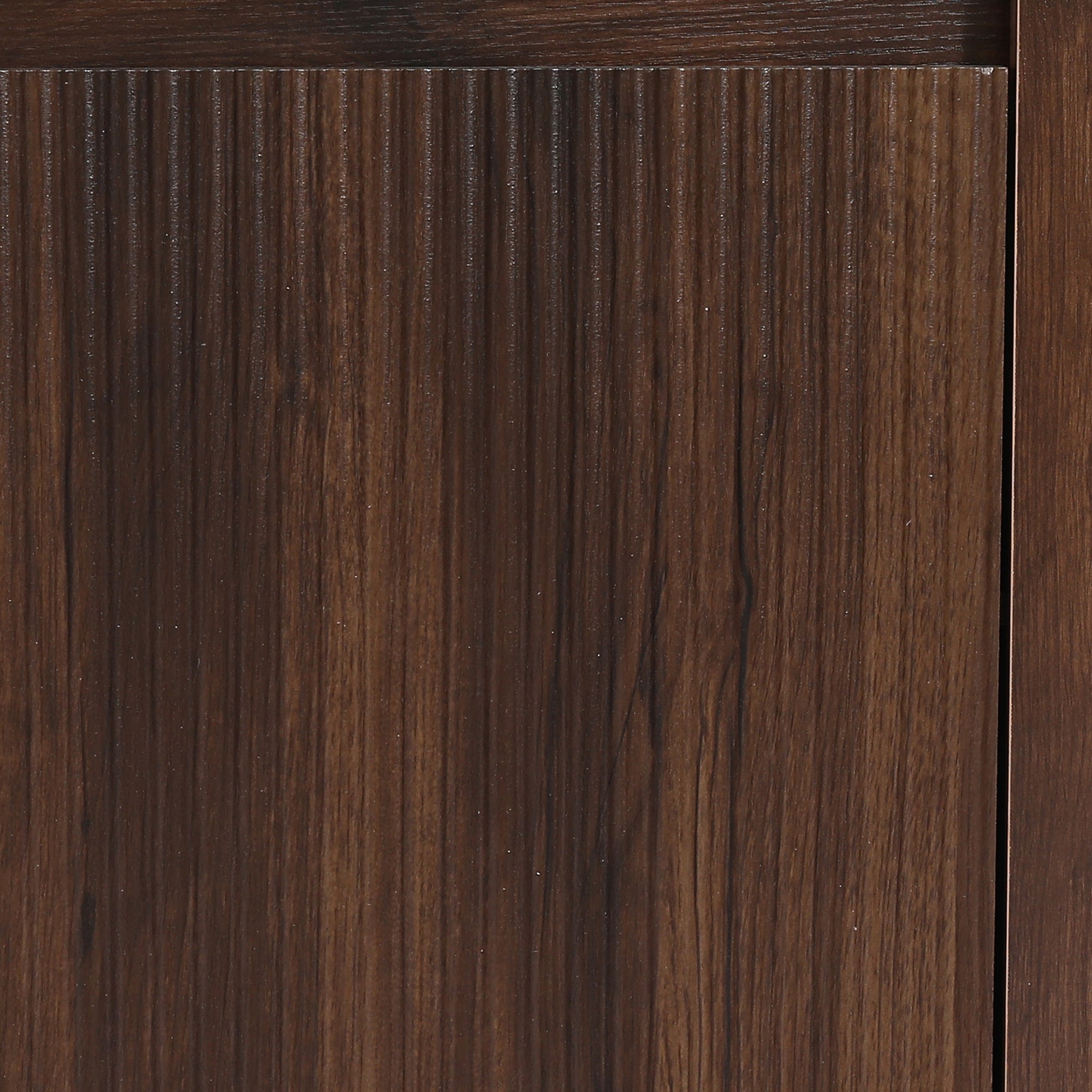 Close-up of dark brown fluted wood paneling with vertical grain texture.