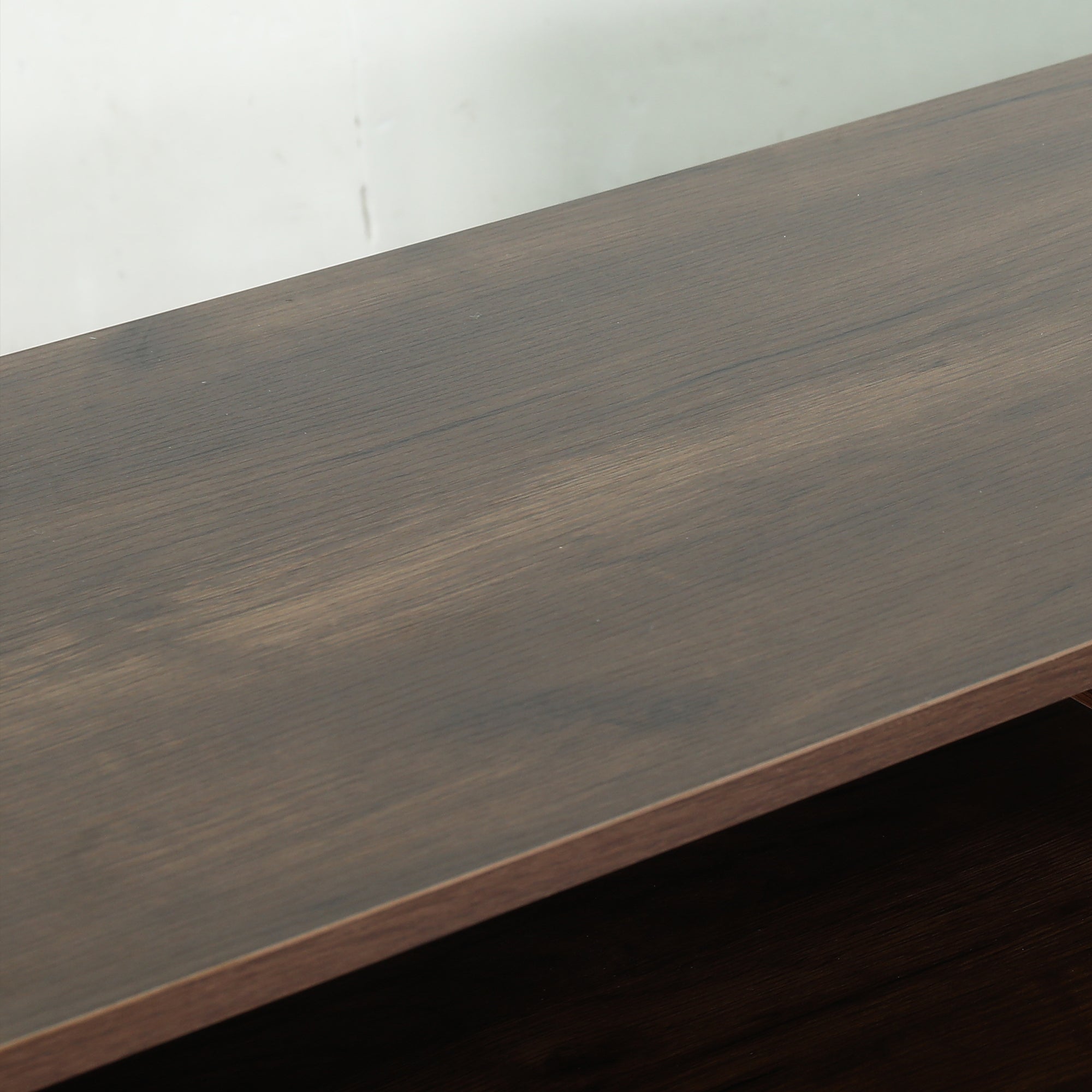 Close-up of a dark brown wood grain furniture surface