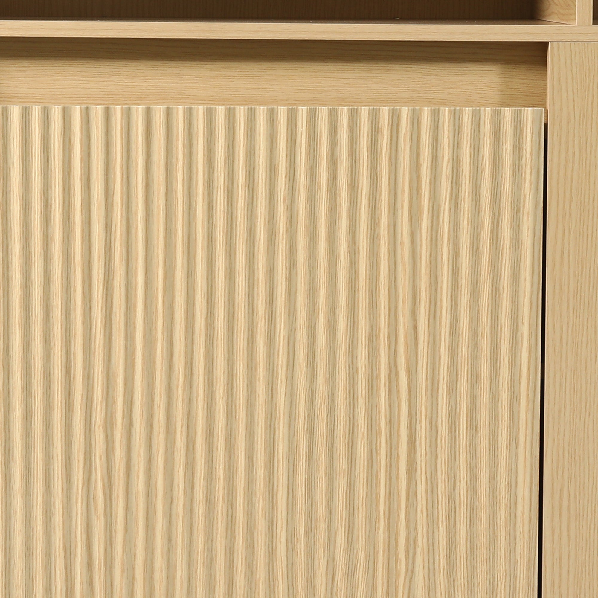 Close-up of light wood furniture with a vertical fluted texture design.