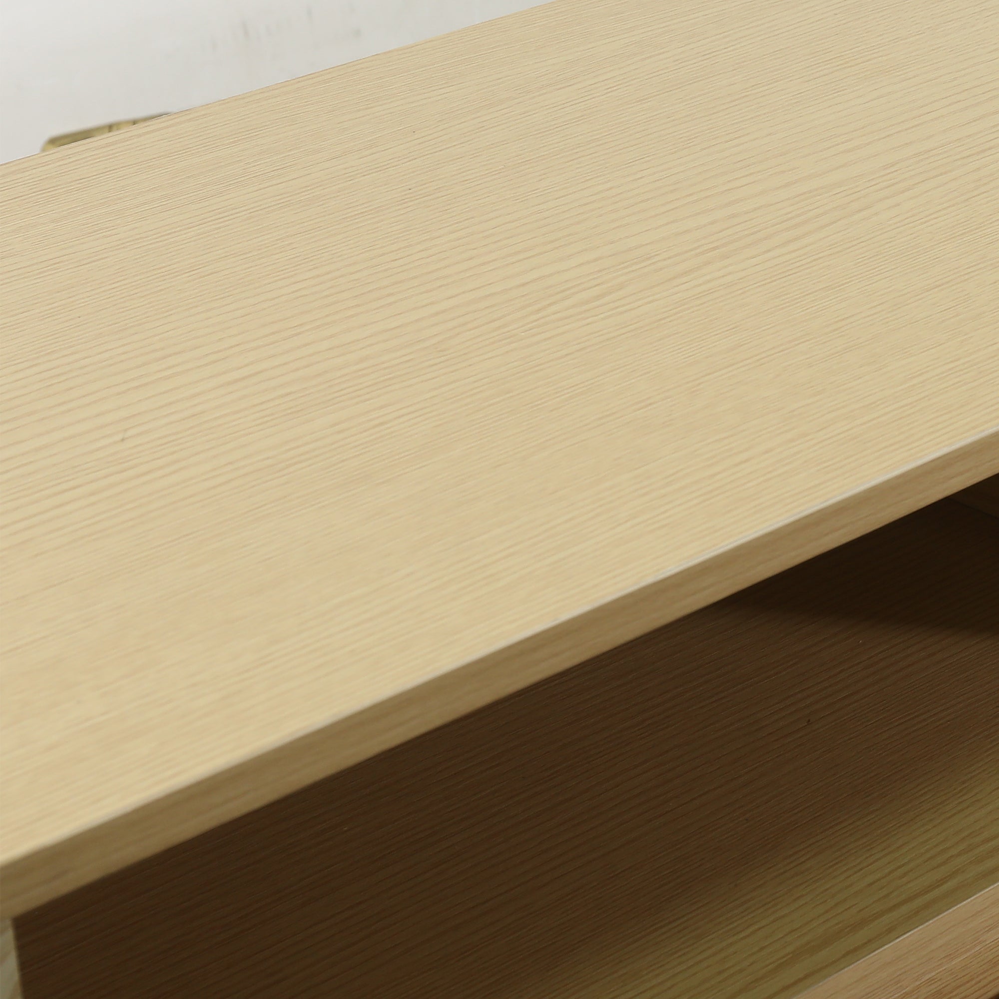 Close-up of a light-colored wood grain furniture shelf surface