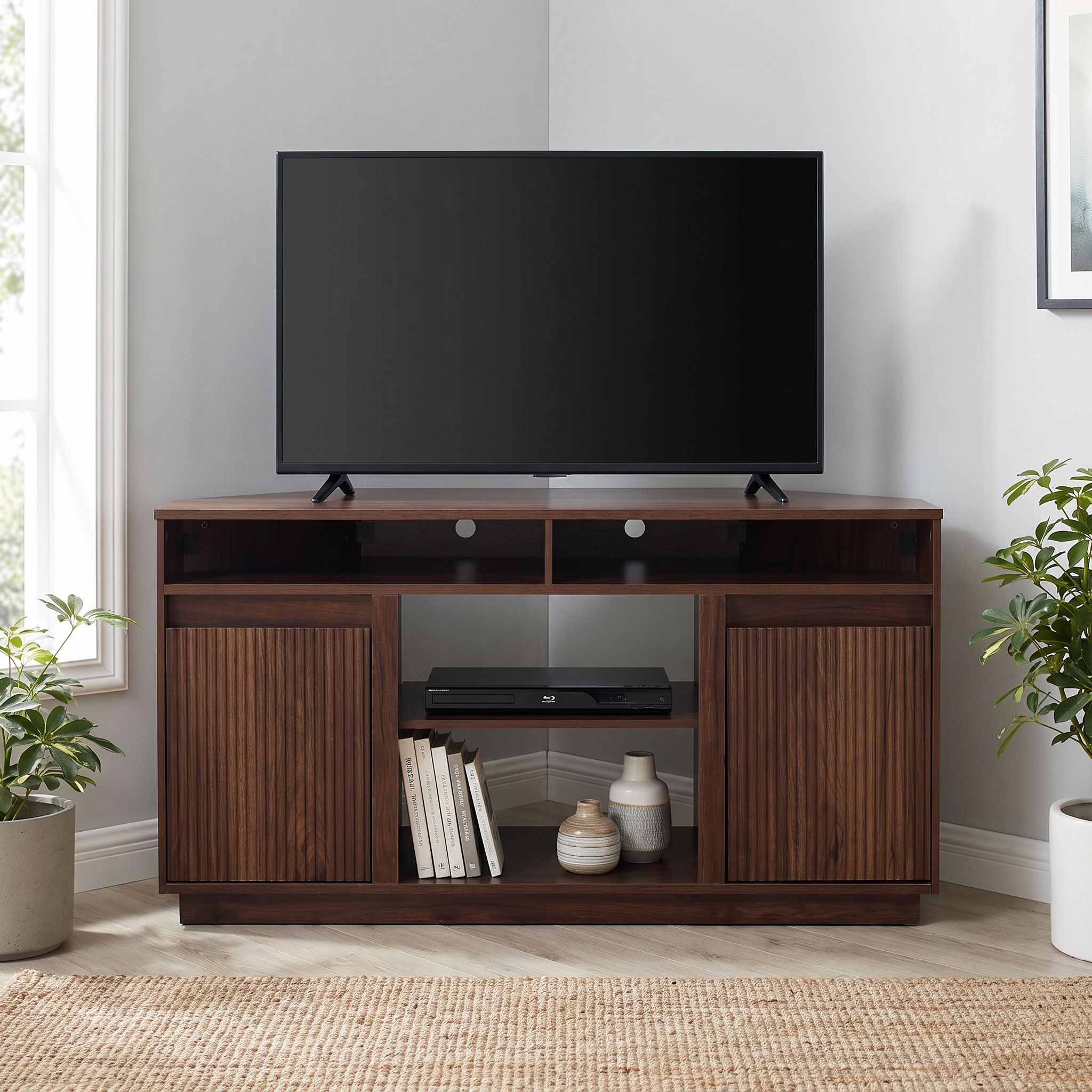 Modern dark walnut TV stand with a large flat screen television in a bright living room