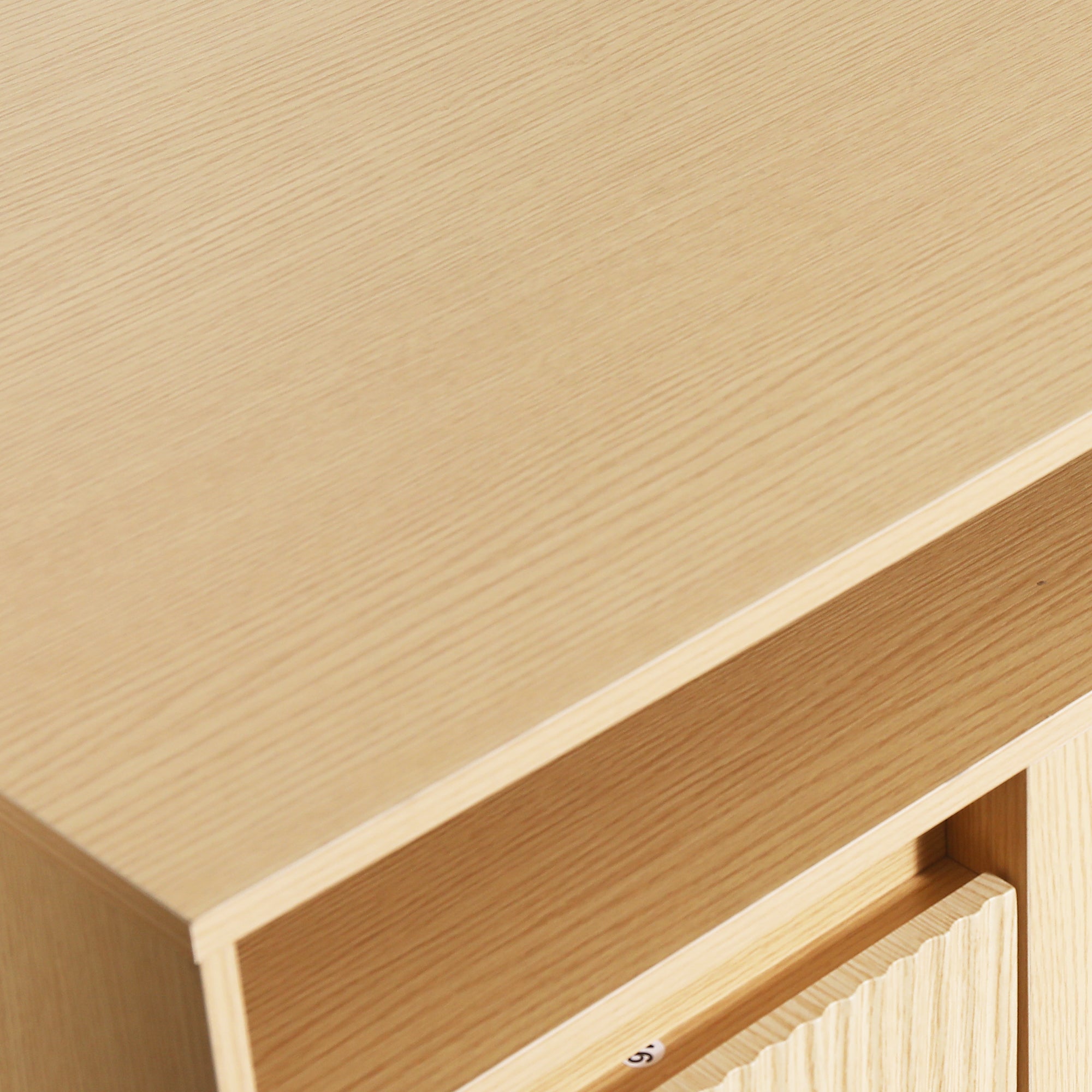 Close-up of a light-colored oak wood cabinet with a clean, modern finish.