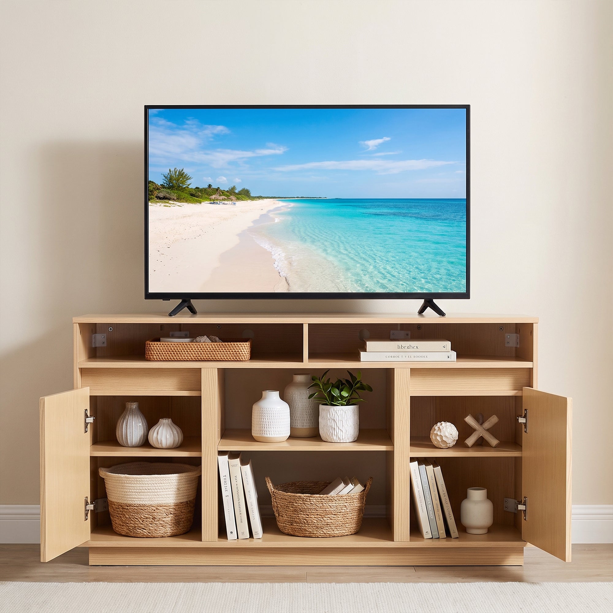 Modern light wood TV stand with open shelving and storage cabinets under a large flat screen TV