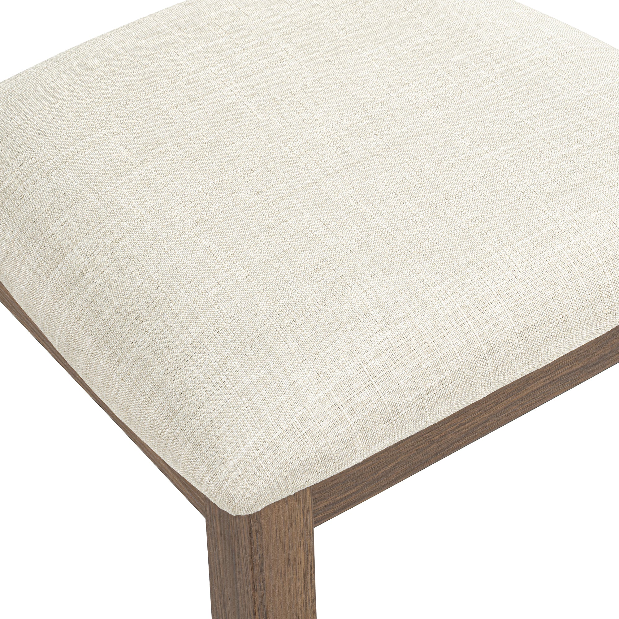 Close-up of a cream fabric upholstered seat with a dark wood frame.