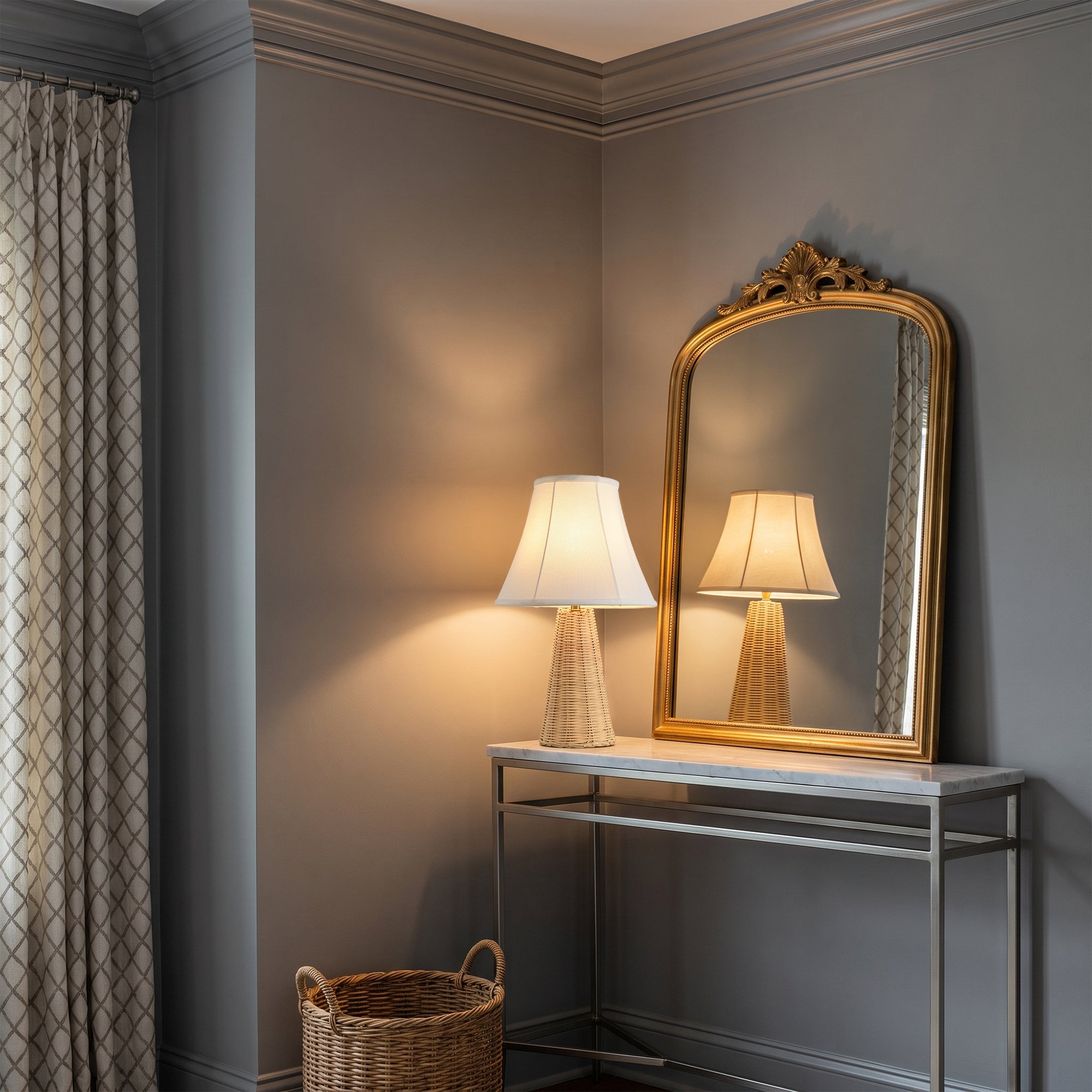 Elegant gold-framed mirror and table lamp on a modern console table in a grey room.
