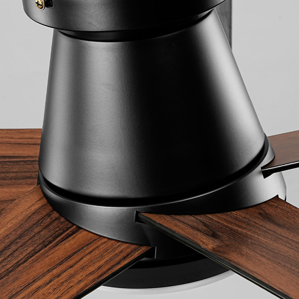 Close-up of a modern black ceiling fan with dark wood grain blades.
