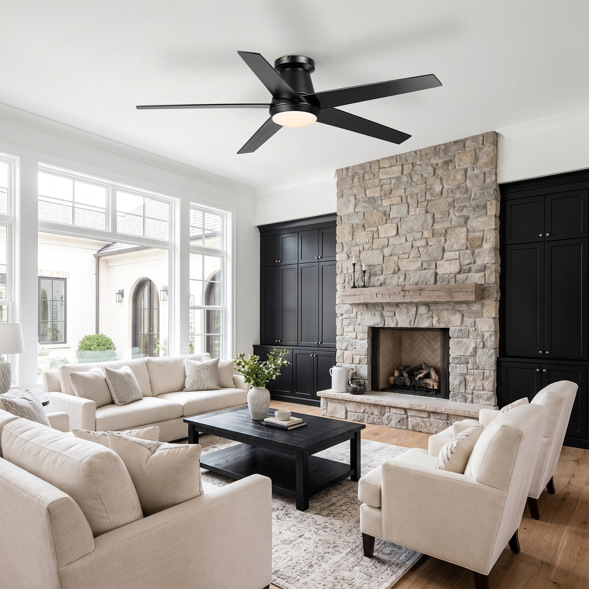 Modern black ceiling fan with integrated light in a living room setting